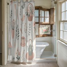 a bathroom with a tub, shower curtain and window