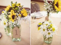 two vases with sunflowers and daisies in them on top of a table