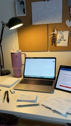 an open laptop computer sitting on top of a white desk