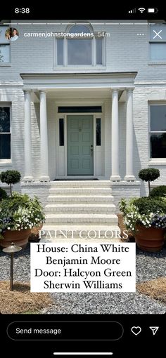 the front door of a house with white pillars and potted plants