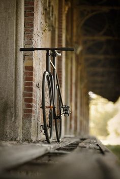 a bike leaning up against a brick wall