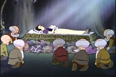 an animated scene with several people surrounding a woman laying on top of a bed surrounded by flowers