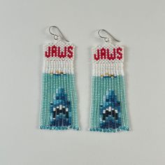 pair of beaded earrings with blue and red beads on white background, featuring the word jalis