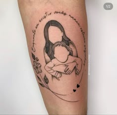 a woman holding a baby in her arms tattoo on the right thigh and lower leg