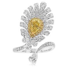 A one-of-a-kind Cocktail ring with a feather-like appearance dazzling with mesmerizing Yellow diamonds and white diamonds - Centre Diamond, GIA Certified Pear-shape Yellow Diamond 0.50 carat - Round Brilliant Cut Yellow Diamonds total 0.09 carat - Pear-shape White Diamonds total 0.50 carats - Round Brilliant Cut White Diamonds total 0.77 carat - Made of 18K White and Yellow Gold - Ring Size US6 (can be sized upon request) Yellow diamond primarily originates from South Africa. Approximately 1 out Dig Jewelry, Yellow Diamonds, Colombian Emeralds, Timeless Jewelry, Fancy Color Diamonds, Yellow Diamond, Exquisite Jewelry, High Jewelry, White Diamonds