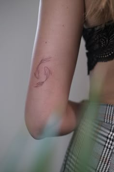 a woman's arm with a tattoo on the left side of her right arm