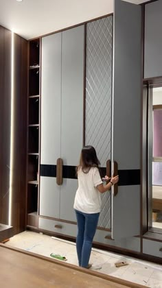 a woman standing in front of a mirrored closet