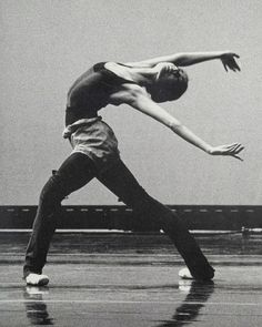 a black and white photo of a man doing a dance move