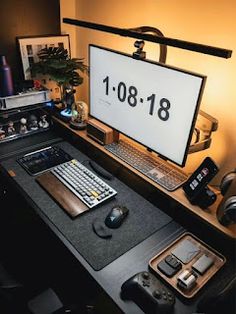 a computer desk with a keyboard, mouse and other electronic devices on top of it