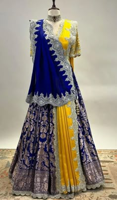 a yellow and blue lehenga is displayed on a mannequin