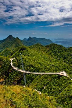 a winding road in the middle of green mountains