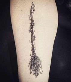 a black and white photo of a plant on the thigh with flowers growing out of it