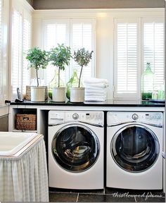 a washer and dryer sitting next to each other in front of a window