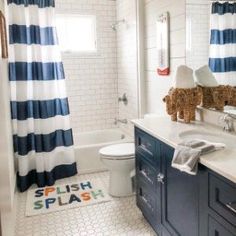 a bathroom with blue and white striped curtains