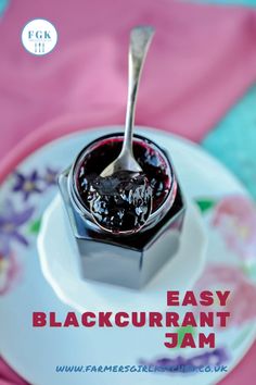 a spoon with jam on it sitting on top of a plate