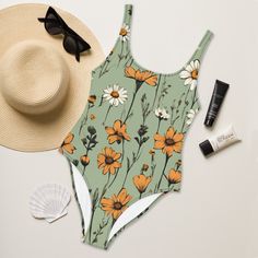 This sage green floral one-piece swimsuit gives boho chic vibes. Meadow flowers give it a bohemian feel. The sage green floral swimsuit is lined on the front side. Flattering fit for most body types. Sizes up to 3XL. Please check the sizing chart between the listing photos. Item description: * 82% polyester, 18% spandex, * fabric weight: 6.78 oz/yd² (230 g/m weight may vary by 5%, * chlorine-resistant fabric, * cheeky fit with a scoop neckline and a low scoop back, * zig-zag stitching, * double- Fitted Floral Print Summer Bodysuit, Summer Floral Print Sleeveless Bodysuit, Sleeveless Summer Bodysuit With Floral Print, Summer Sleeveless Floral Bodysuit, Green Printed Beach Bodysuit, Green Floral Print Summer Bodysuit, Green Printed Bodysuit For The Beach, Summer Sleeveless Printed Bodysuit, Casual One-piece Floral Print Bodysuit