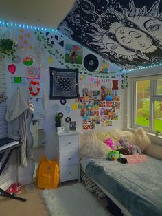 a bedroom decorated with pictures and decorations on the walls, lights strung from the ceiling