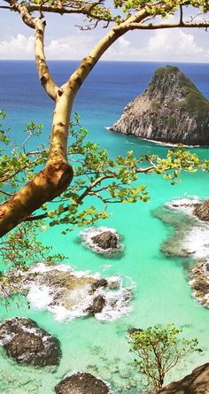 the water is crystal blue and green with rocks on both sides in front of it