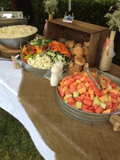 an assortment of food on a table at a wedding or other function, including carrots, cauliflower and cucumbers