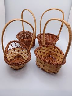 three wicker baskets sitting on top of a white table