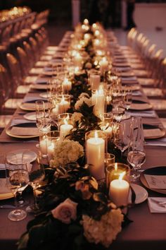 a long table is set with candles and flowers for an elegant dinner or wedding reception