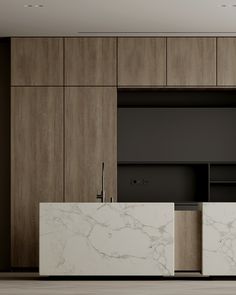 an empty kitchen with marble counter tops and wooden cupboards on the wall behind it