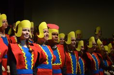 a group of women in red and blue uniforms standing next to each other on stage