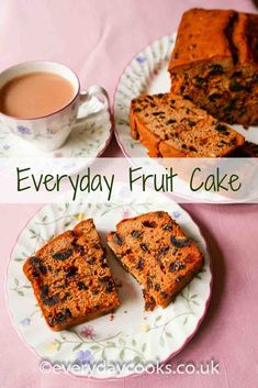 two plates with slices of fruit cake next to a cup of tea and a fork