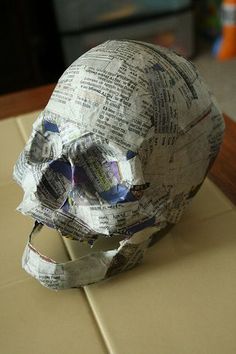 a paper mache skull sitting on top of a table