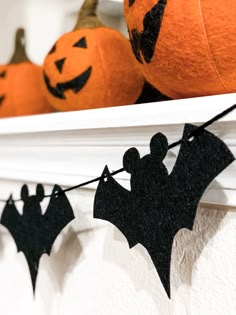 bats and pumpkins are hanging on the mantle