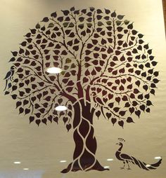 a tree with leaves and a bird on it's trunk is shown in black against a white background