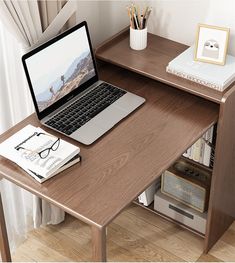 an open laptop computer sitting on top of a wooden desk next to a book shelf