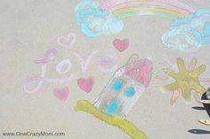 a child's drawing on the ground with chalk and crayon pencils