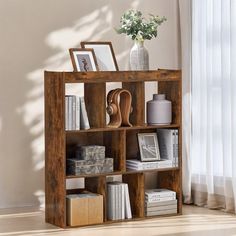 a wooden shelf with books and pictures on it