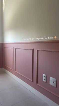 a bathroom with pink walls and white tile flooring in an empty room next to a window