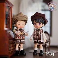 two figurines that are standing next to each other on a wooden table with a clock in the background