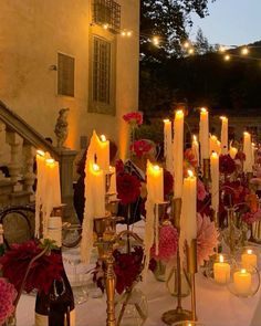 a table with candles and flowers on it