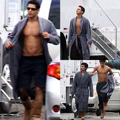 the man is walking down the street with his robe over his shoulders and no shirt on