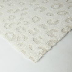 a white rug with an animal print pattern on the top and bottom part of it