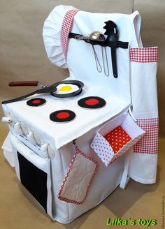 an oven made out of white paper with red and black trimmings on it