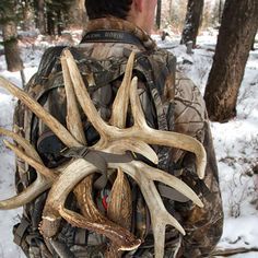 a man with antlers on his back in the snow