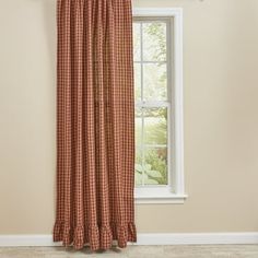 the curtain is hanging in front of a window with a checkered pattern on it