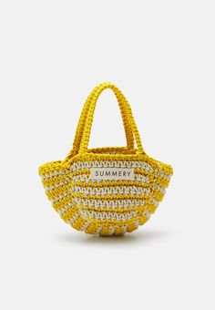 a yellow and white straw bag with the word summer printed on it, sitting in front of a white background