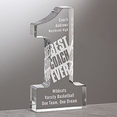 a clear glass trophy with the words best coach on it's front and bottom