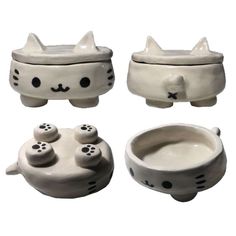 three ceramic bowls with cats faces and paws on the top one has a cat's head