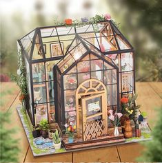 a doll house with flowers and plants inside