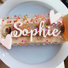 a white plate topped with a piece of cake covered in confetti and sprinkles