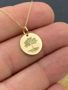 "Tree of life necklace, Tree Necklace, solid Gold k14, Custom Tree of life necklace, delicate jewelry, Gold necklace, charm necklace 14k Solid Gold Choose What Size You Want the Pendant Using The First Option Box Choose If you Want Thinner, Thicker  Or Without Chain Using The Second Option Box Photos Are For The 0.5 inch Diameter Pendant Pendant thickness : 0.5mm  Contact us if you want it thicker Inner diameter of jump ring : 4mm Contact us if you need it bigger              No1 chain width : 0.87mm                 No2 chain width : 1.30mm     ♥  Material of pendant and chain: Solid Gold k14  ♥  Packaging: All of our jewelry are beautifully boxed and ready for gifting For more personalized designs take a look here: ♥ www.etsy.com/listing/736955132 ♥ www.etsy.com/listing/819494857 ♥ www.et Solid Gold Necklace, Tree Necklace, Tree Of Life Necklace, Tree Pendant, Delicate Jewelry, Mantra, Tree Of Life, Personalized Jewelry, Charm Necklace