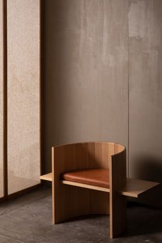 a wooden bench sitting in front of a sliding glass door next to a wall with a brown leather seat on it