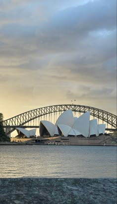 the sydney opera house and harbour bridge at sunset